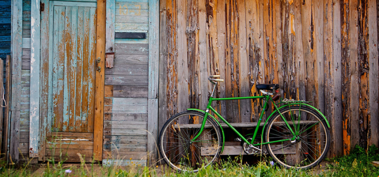 Old wooden wall and green bicycle Old wooden wall and green bicycle